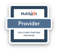 A HubSpot Provider badge with a tablet displaying the HubSpot logo and the words "Solutions Partner Program."
