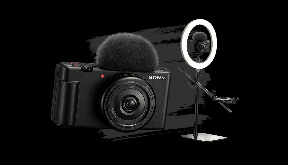 A Sony camera with a microphone, a ring light, and a small camera mounted on a stand for filming or vlogging.