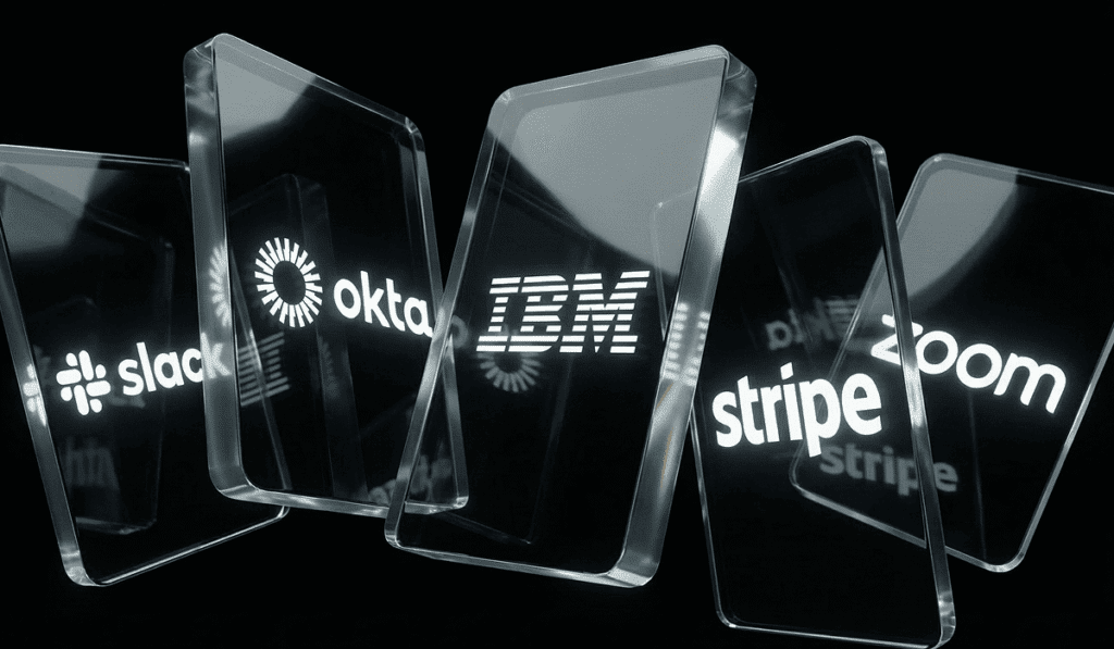 Glass panels displaying the logos of Slack, Okta, IBM, Stripe, and Zoom against a black background.