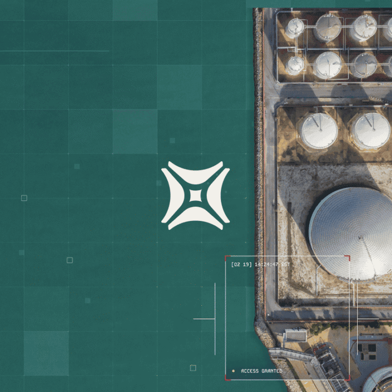 Aerial view of a rooftop with storage tanks and a drone logo over a green surface, with a timestamp and "Access Granted"
